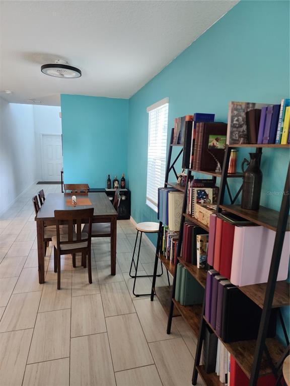 12537 Timber Moss Lane Riverview, FL 33579 - Photo 9 of 16 a dining room with furniture and wooden floor