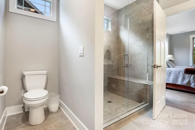 a bathroom with a toilet and a shower