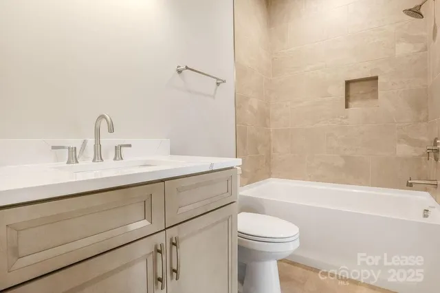a bathroom with a sink a toilet and bathtub