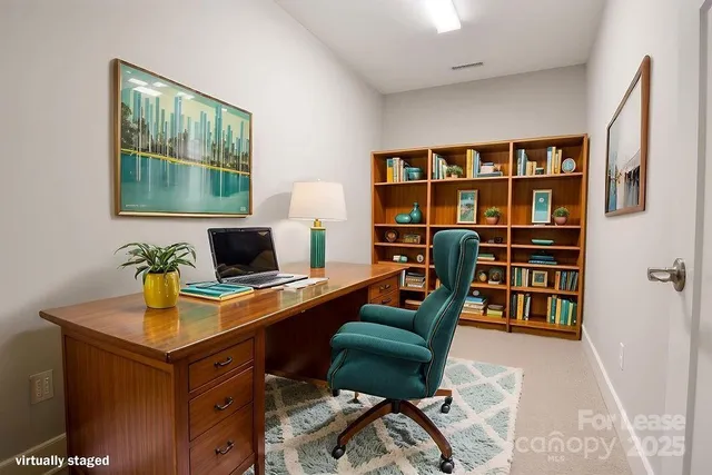 a view of a workspace with furniture and a bookshelf