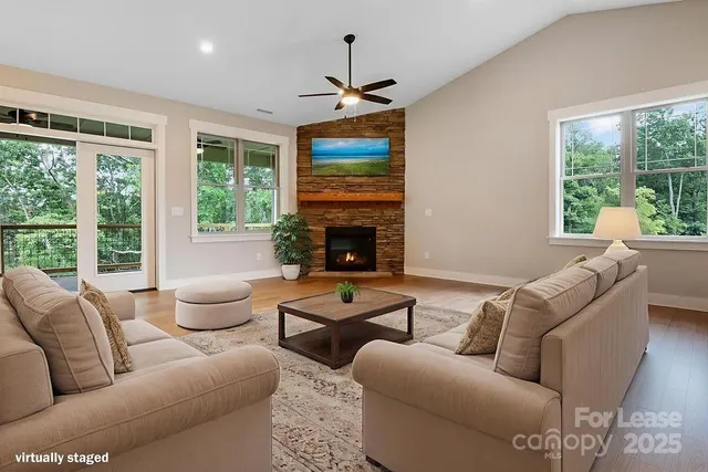 a living room with furniture a fireplace and a window