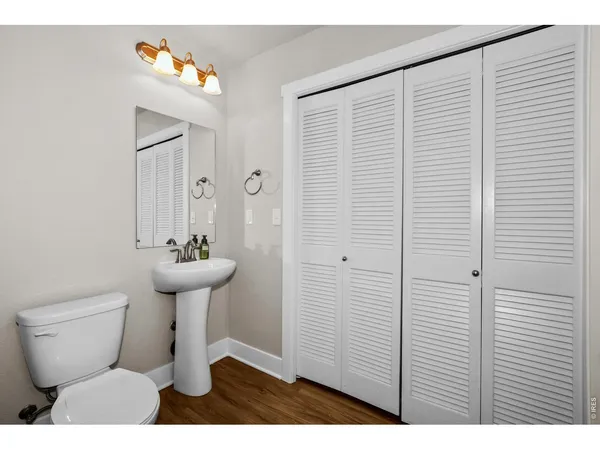 a bathroom with a sink vanity mirror toilet and bathtub