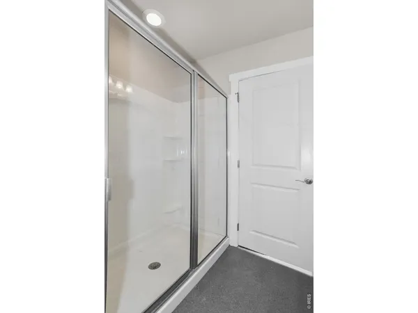 a bathroom with a granite countertop sink toilet a mirror and shower