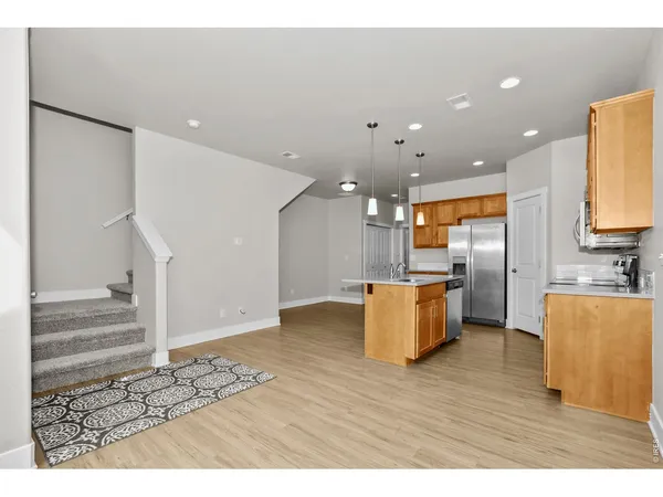 a view of kitchen with furniture and wooden floor