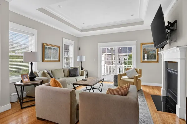 a living room with furniture large window and flat screen tv