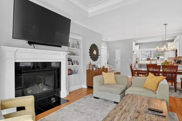 a living room with furniture a flat screen tv and a fireplace