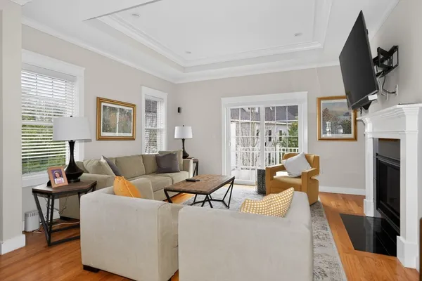 a living room with furniture large window and a flat screen tv