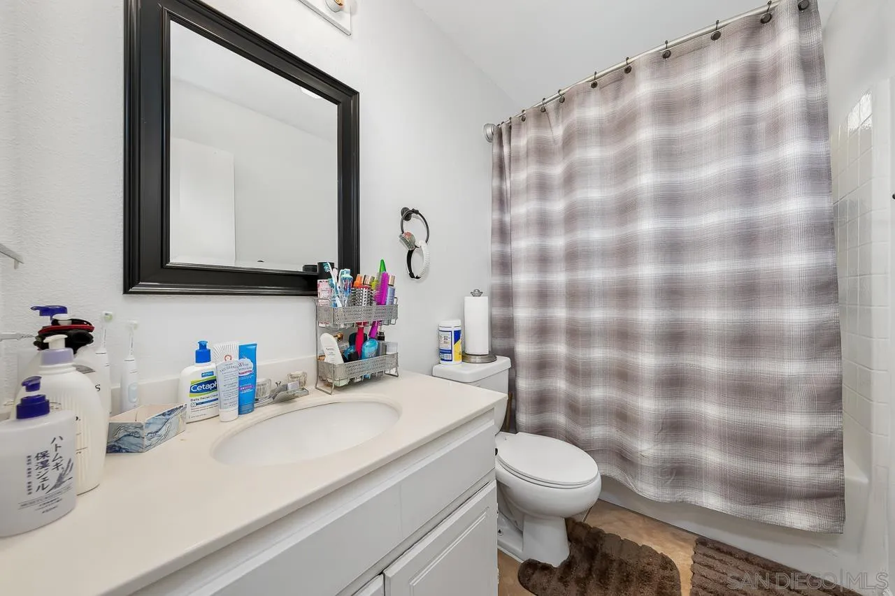 1322 Mill Valley Road Chula Vista, CA 91913 - Photo 20 of 25 a bathroom with a sink a toilet and a mirror
