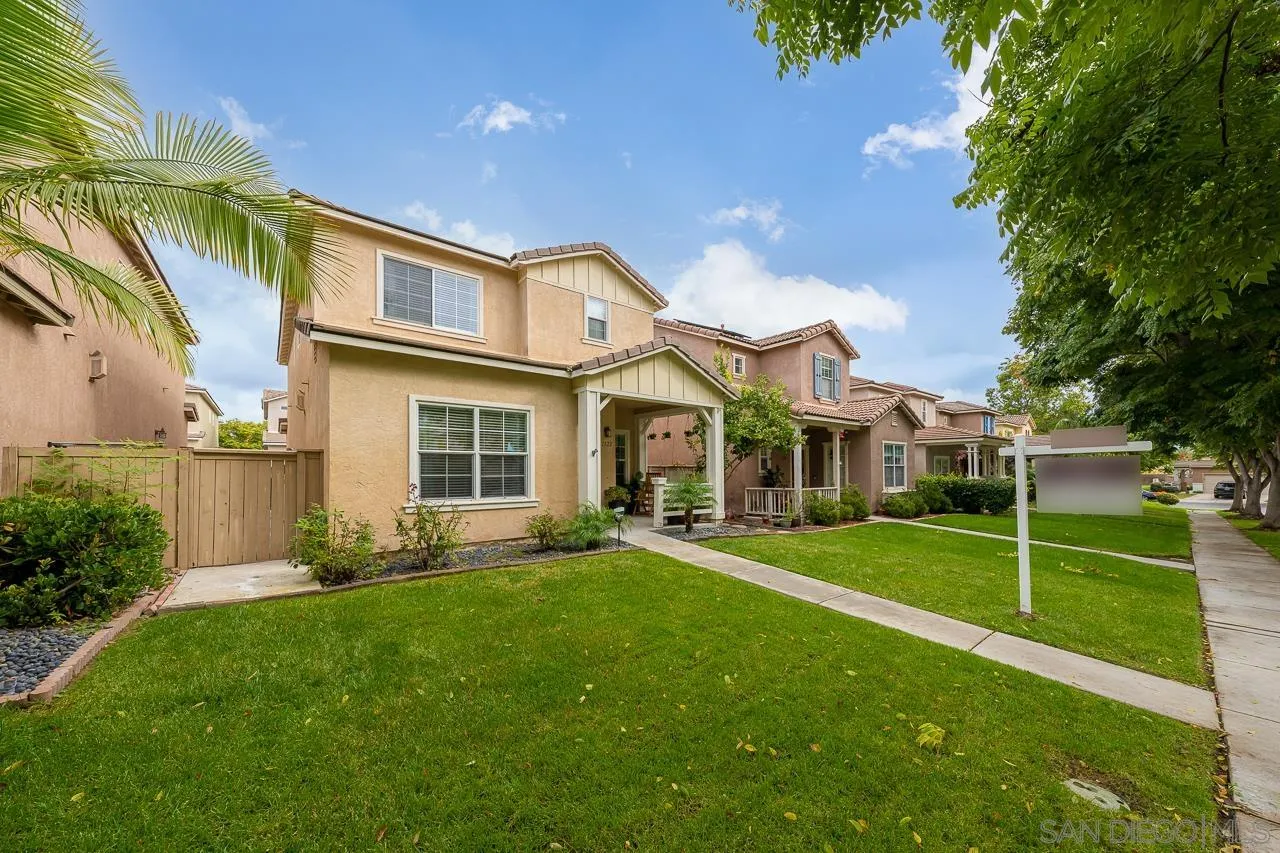 1322 Mill Valley Road Chula Vista, CA 91913 - Photo 2 of 25 a front view of a house with a yard and trees