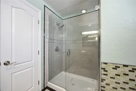 a bathroom with a shower and a tub