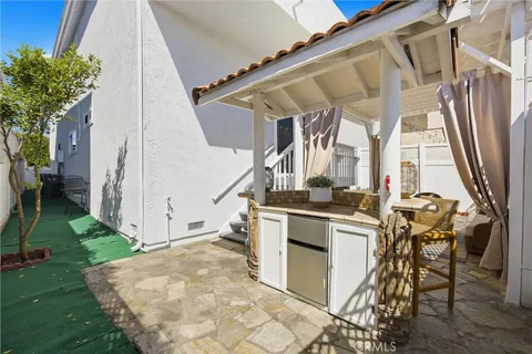 a view of outdoor kitchen with seating area