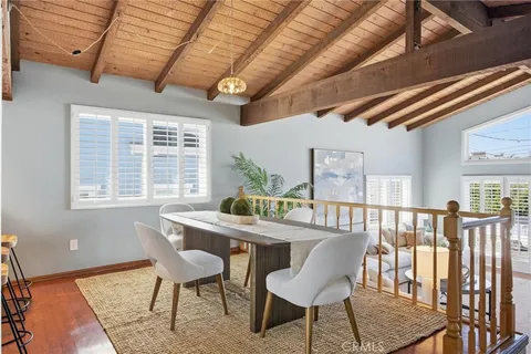 a dining room with furniture a rug and wooden floor