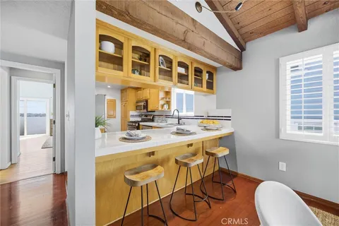 a kitchen with a sink and chairs