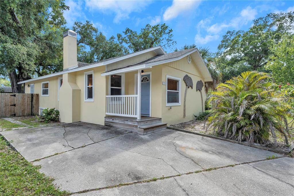 4936 Rosedale Place North St. Petersburg, FL 33714 - Photo 1 of 1 a view of a small house with a yard and plants