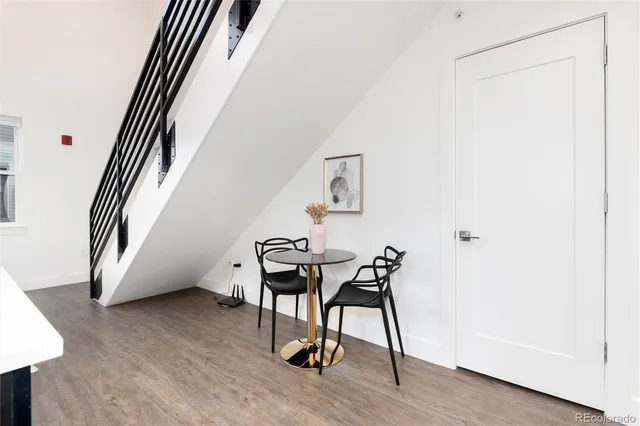 a view of a hallway with furniture and wooden floor