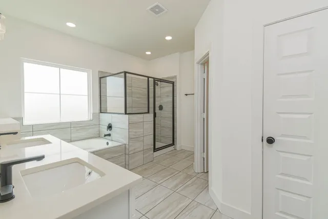 a bathroom with a tub sink and mirror