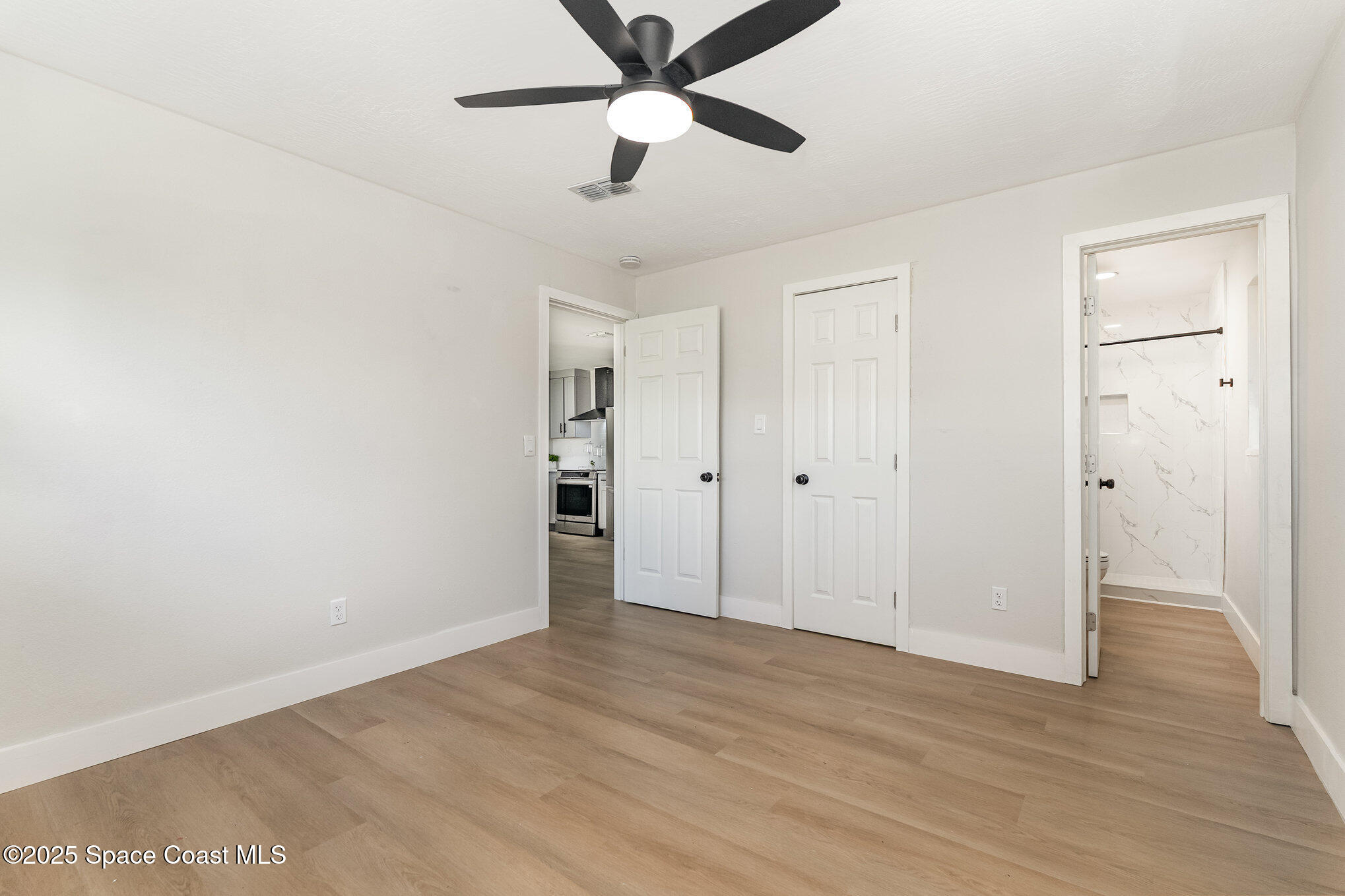 1029 Illinois Road Cocoa, FL 32927 - Photo 12 of 27 a view of empty room with wooden floor