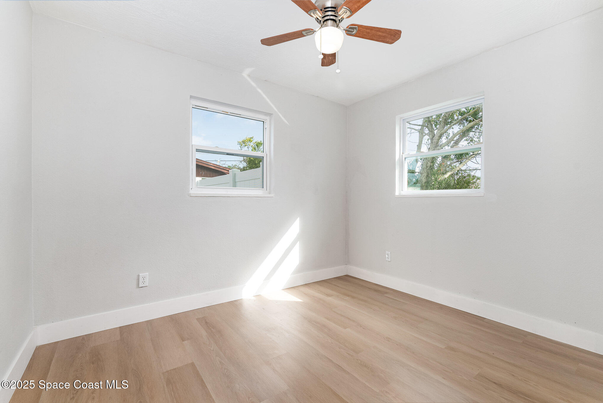 1029 Illinois Road Cocoa, FL 32927 - Photo 16 of 27 wooden floor in an empty room with a window