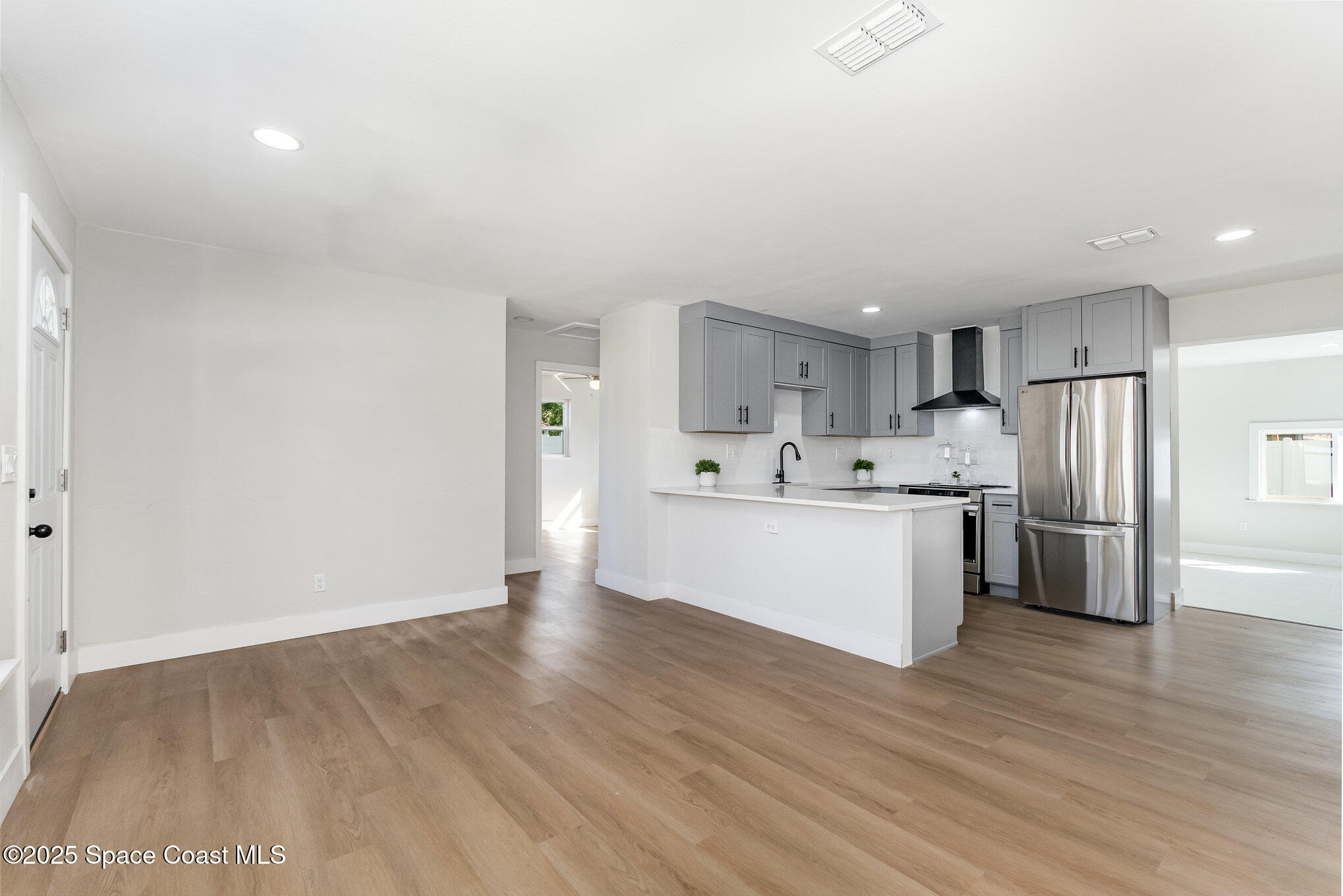 1029 Illinois Road Cocoa, FL 32927 - Photo 6 of 27 a view of kitchen with stainless steel appliances wooden cabinets and wooden floor