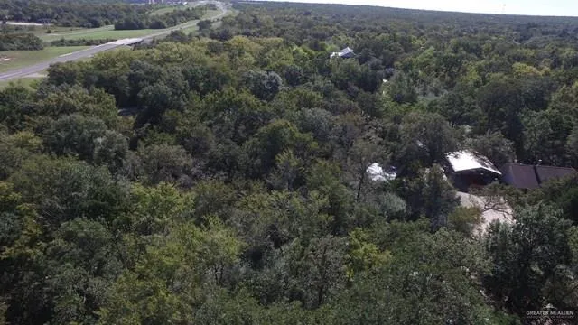 an aerial view of house with yard and green space