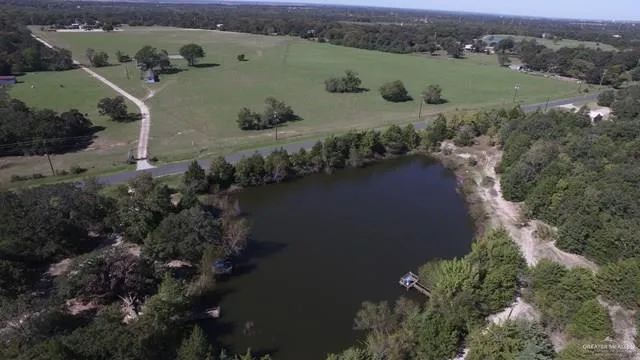 a view of a lake with a yard and mountain view