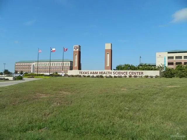 a view of outdoor space with green field and trees