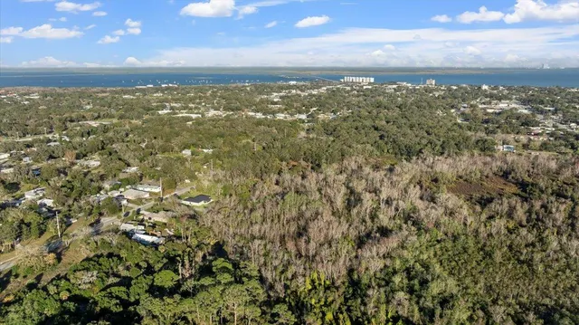 an aerial view of a residential houses with city view