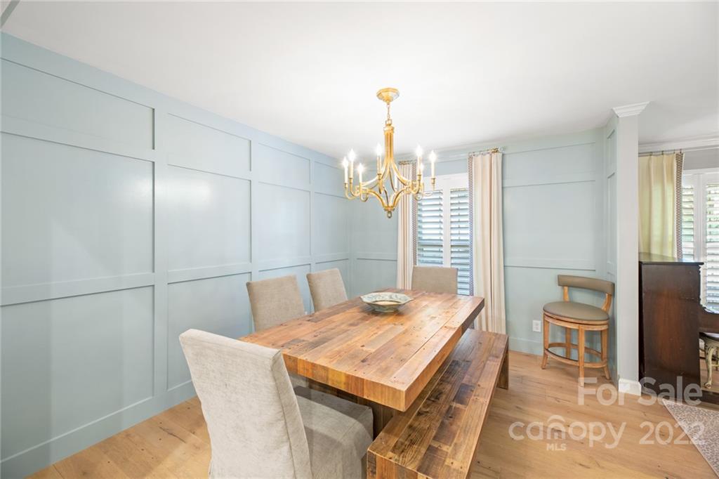 620 Trail Ridge Road Matthews, NC 28105 - Photo 11 of 34 a dining room with a table chairs and a wooden floor