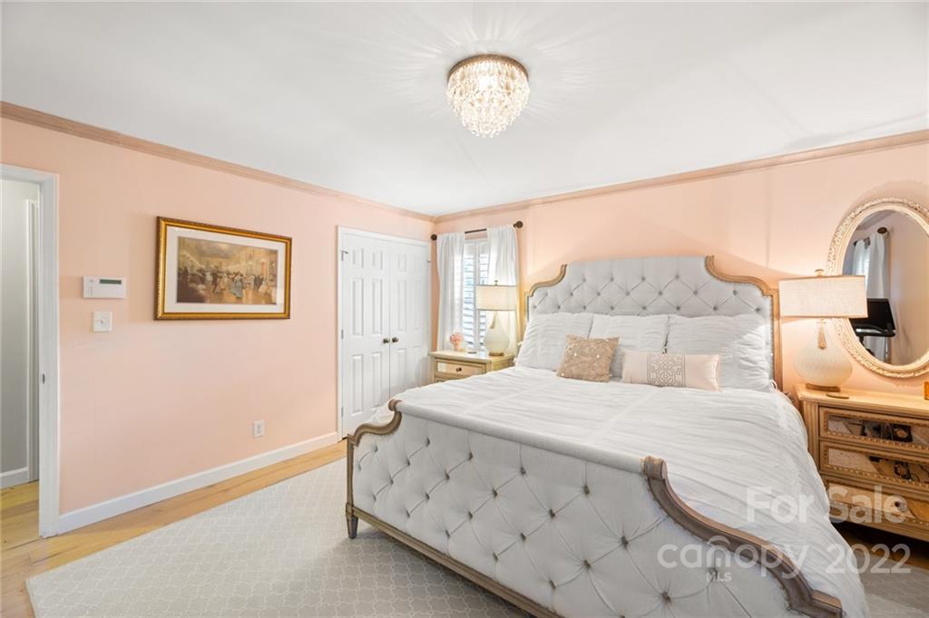 620 Trail Ridge Road Matthews, NC 28105 - Photo 21 of 34 a bedroom with a bed a clock on the wall and dresser