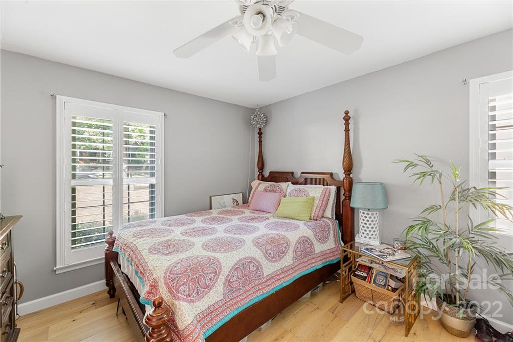 620 Trail Ridge Road Matthews, NC 28105 - Photo 25 of 34 a bedroom with a bed and a chandelier