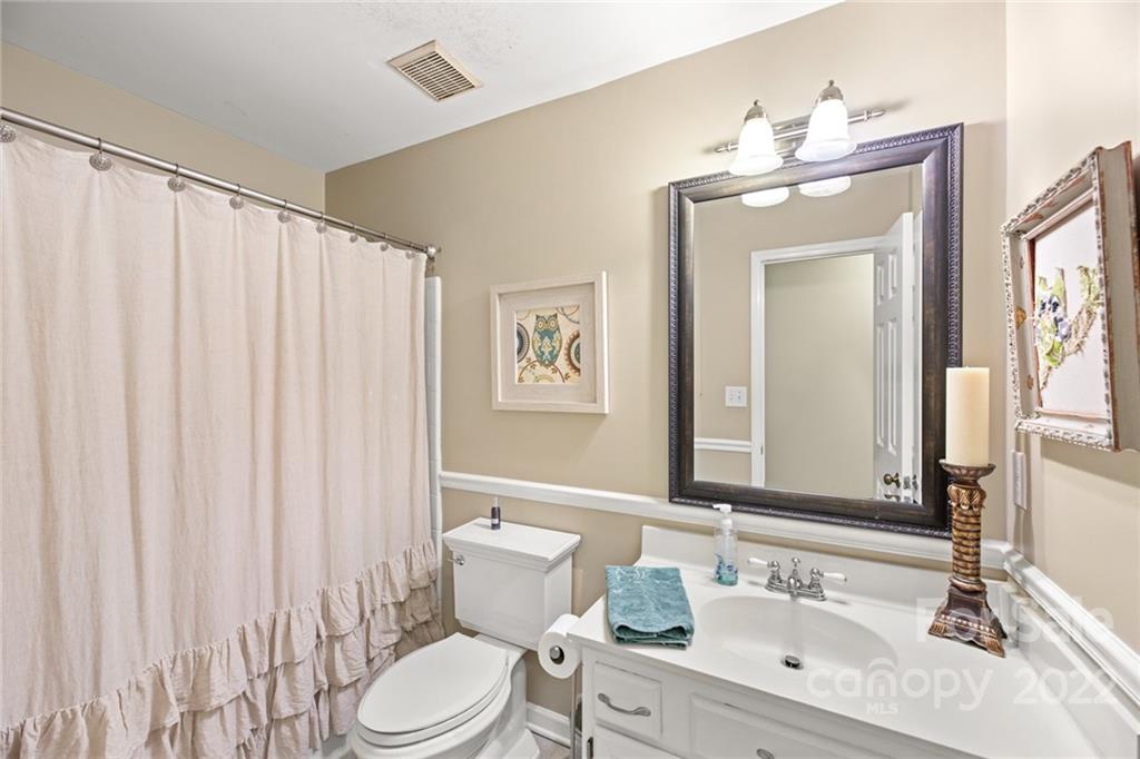 620 Trail Ridge Road Matthews, NC 28105 - Photo 26 of 34 a bathroom with a granite countertop sink toilet and mirror