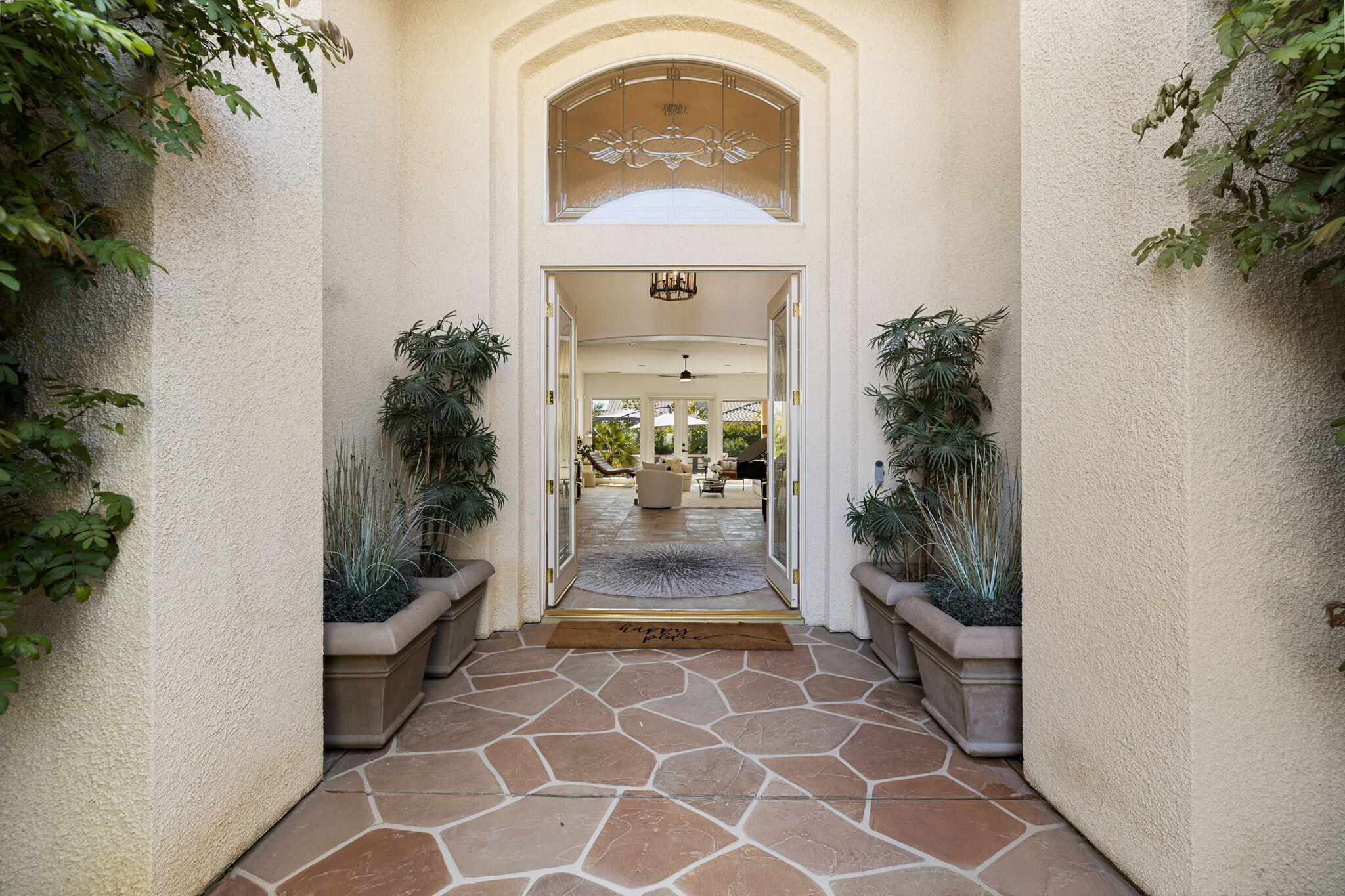 19 Trafagar Square Rancho Mirage, CA 92270 - Photo 13 of 54 an entryway door with potted plants in front of it