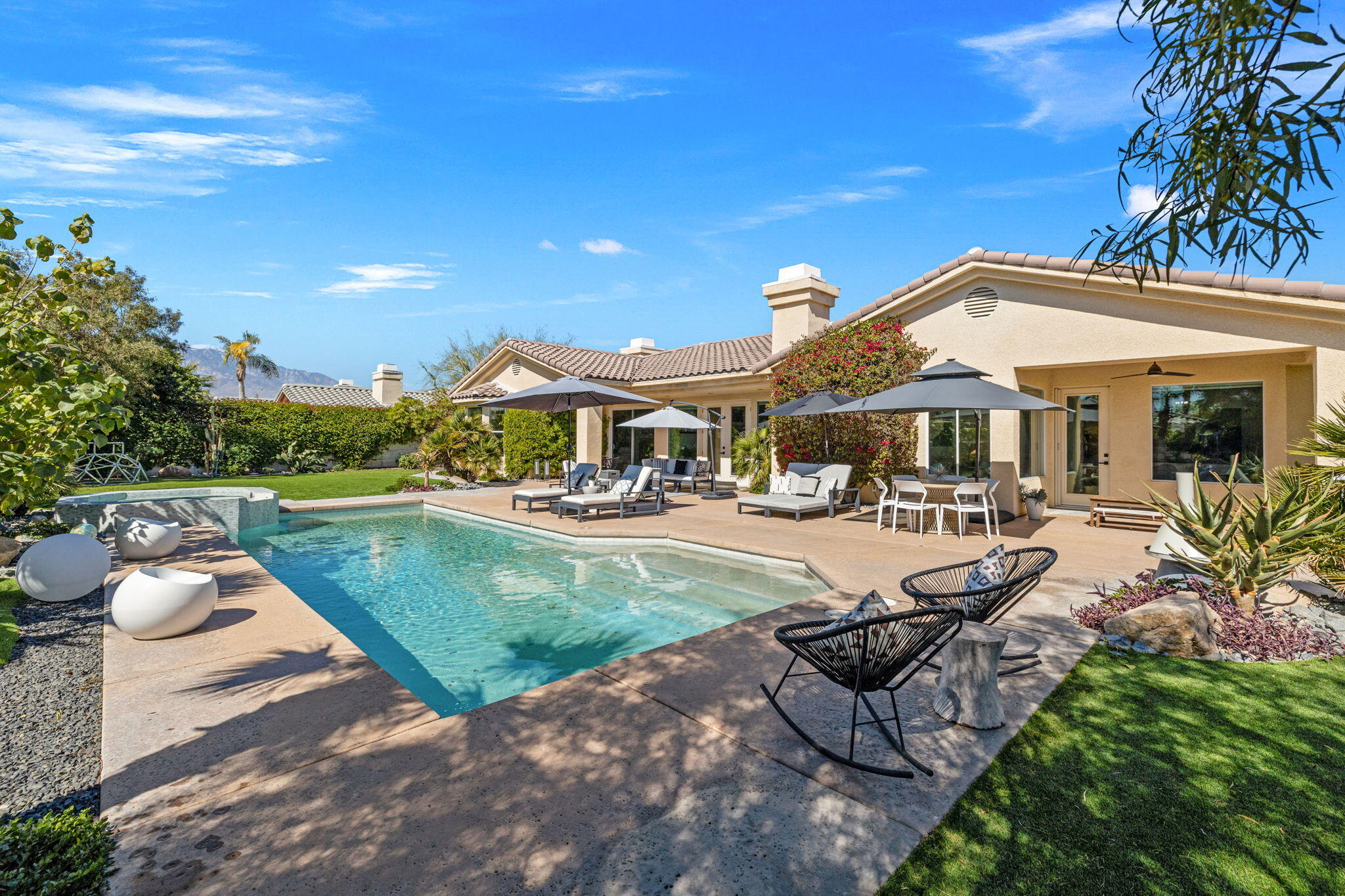 19 Trafagar Square Rancho Mirage, CA 92270 - Photo 14 of 54 a view of a house with swimming pool and sitting area