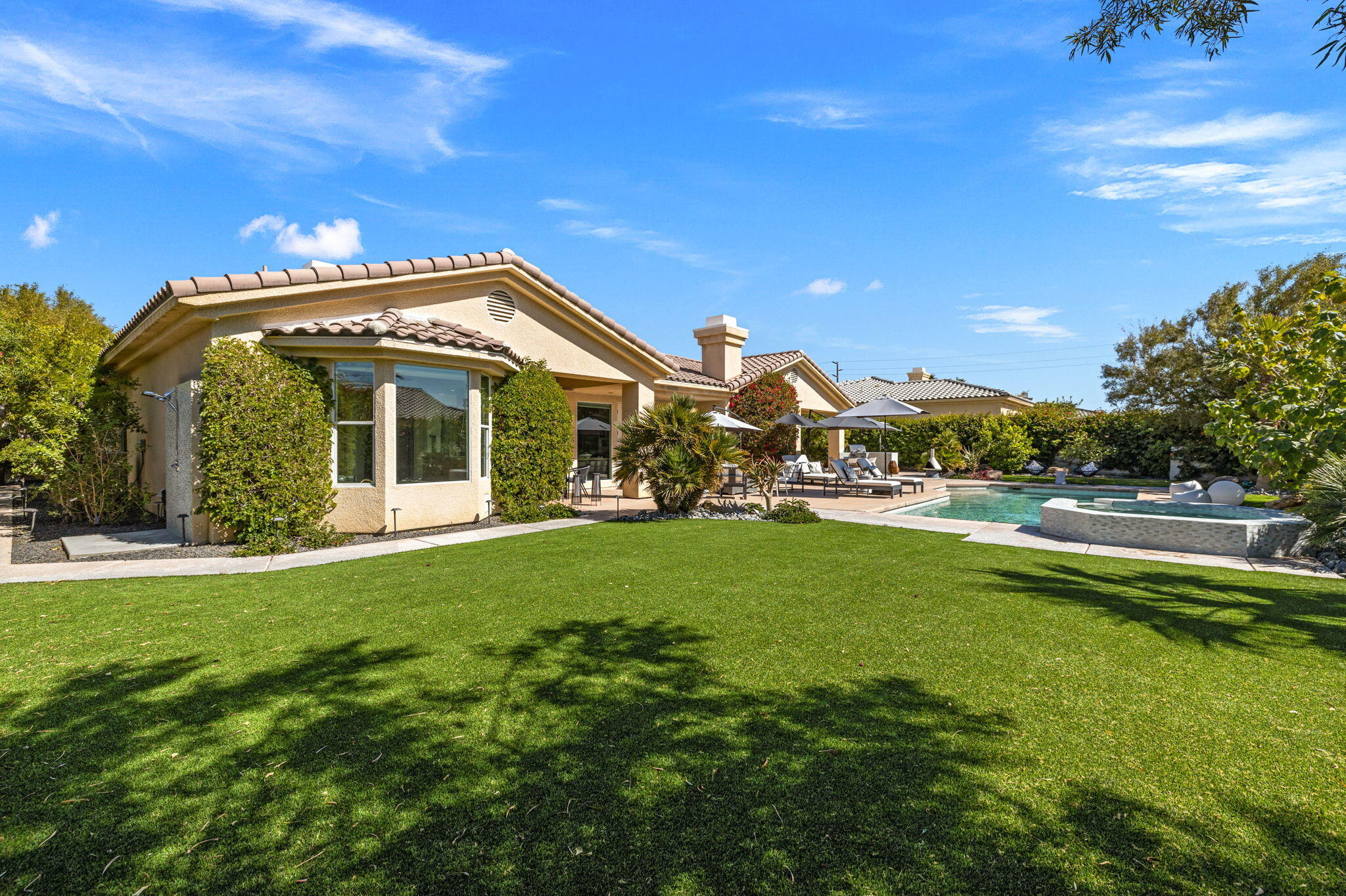 19 Trafagar Square Rancho Mirage, CA 92270 - Photo 15 of 54 a front view of a house with garden