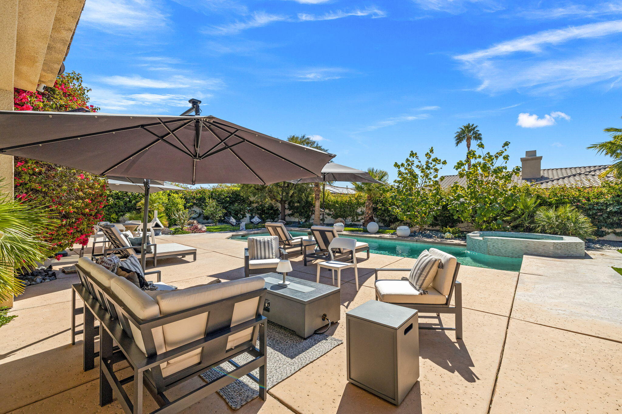 19 Trafagar Square Rancho Mirage, CA 92270 - Photo 17 of 54 a view of a patio with chairs and umbrella