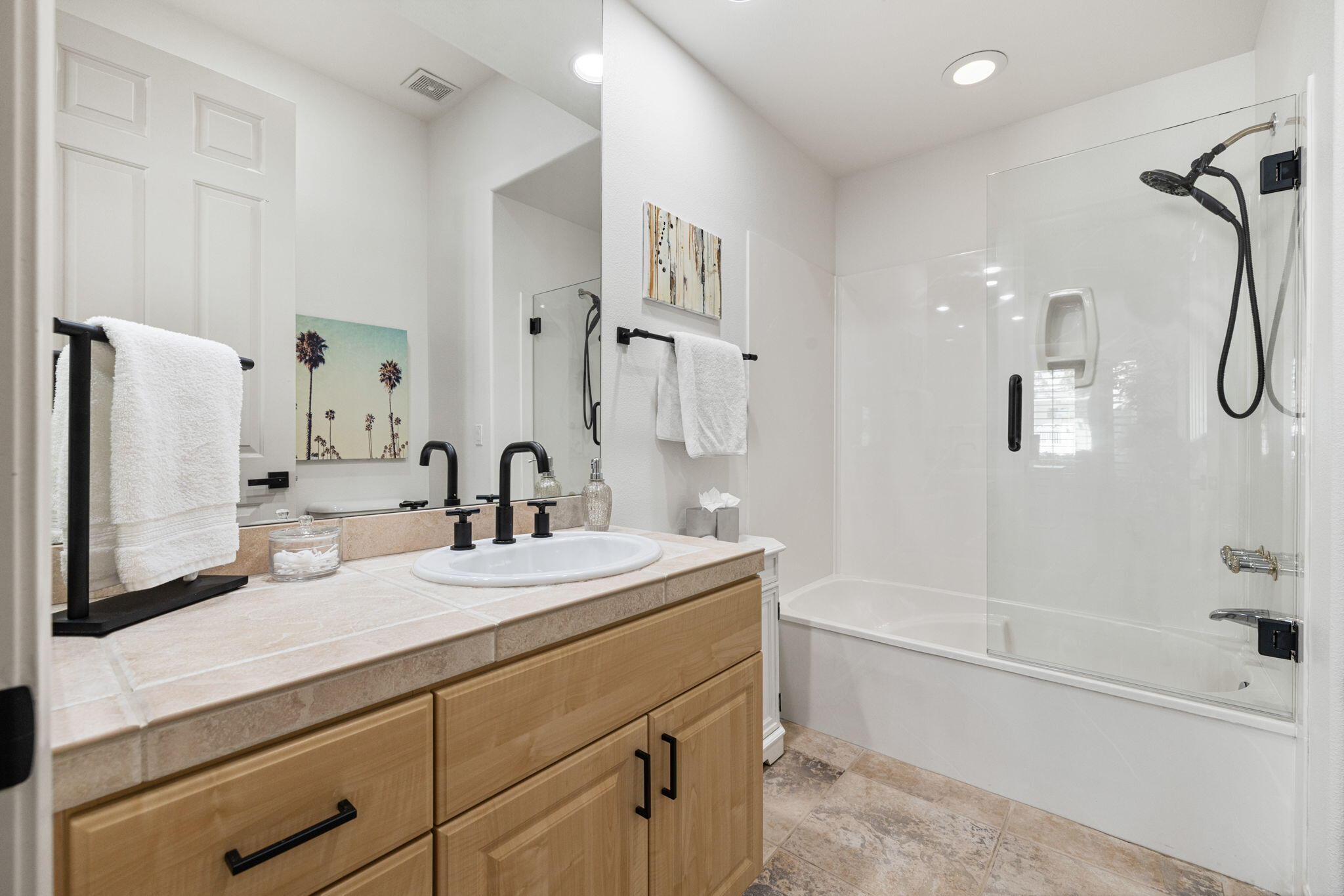 19 Trafagar Square Rancho Mirage, CA 92270 - Photo 20 of 54 a bathroom with a double vanity sink a mirror a bathtub and shower