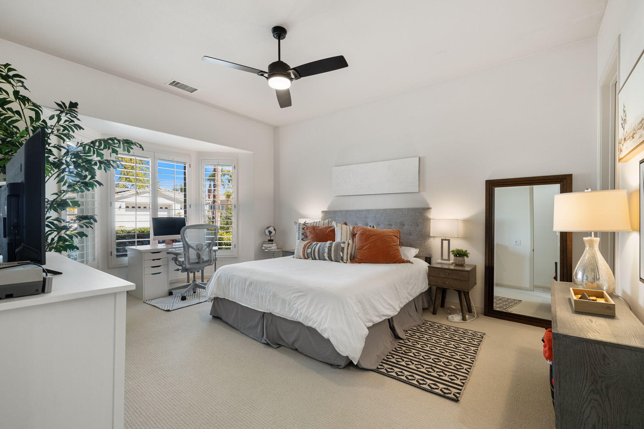 19 Trafagar Square Rancho Mirage, CA 92270 - Photo 21 of 54 a bedroom with a balcony a bed and a chandelier