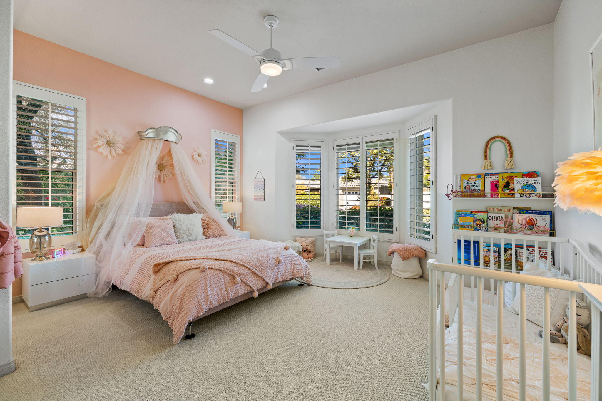 19 Trafagar Square Rancho Mirage, CA 92270 - Photo 25 of 54 a bedroom with furniture and a book shelf