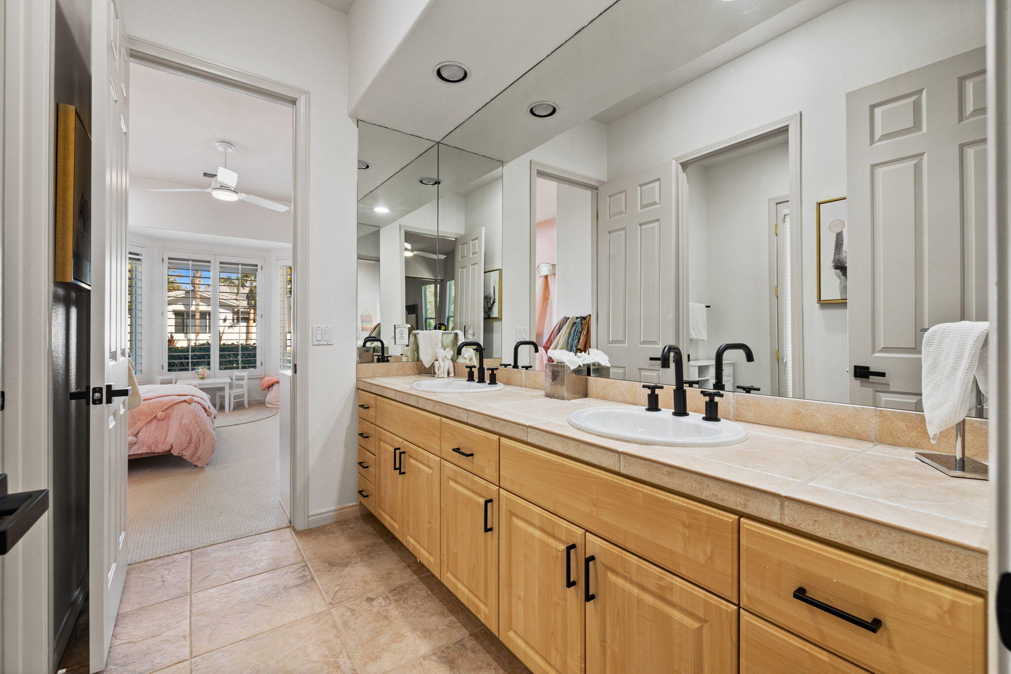 19 Trafagar Square Rancho Mirage, CA 92270 - Photo 26 of 54 a spacious en suite bathroom with double sink and a mirror