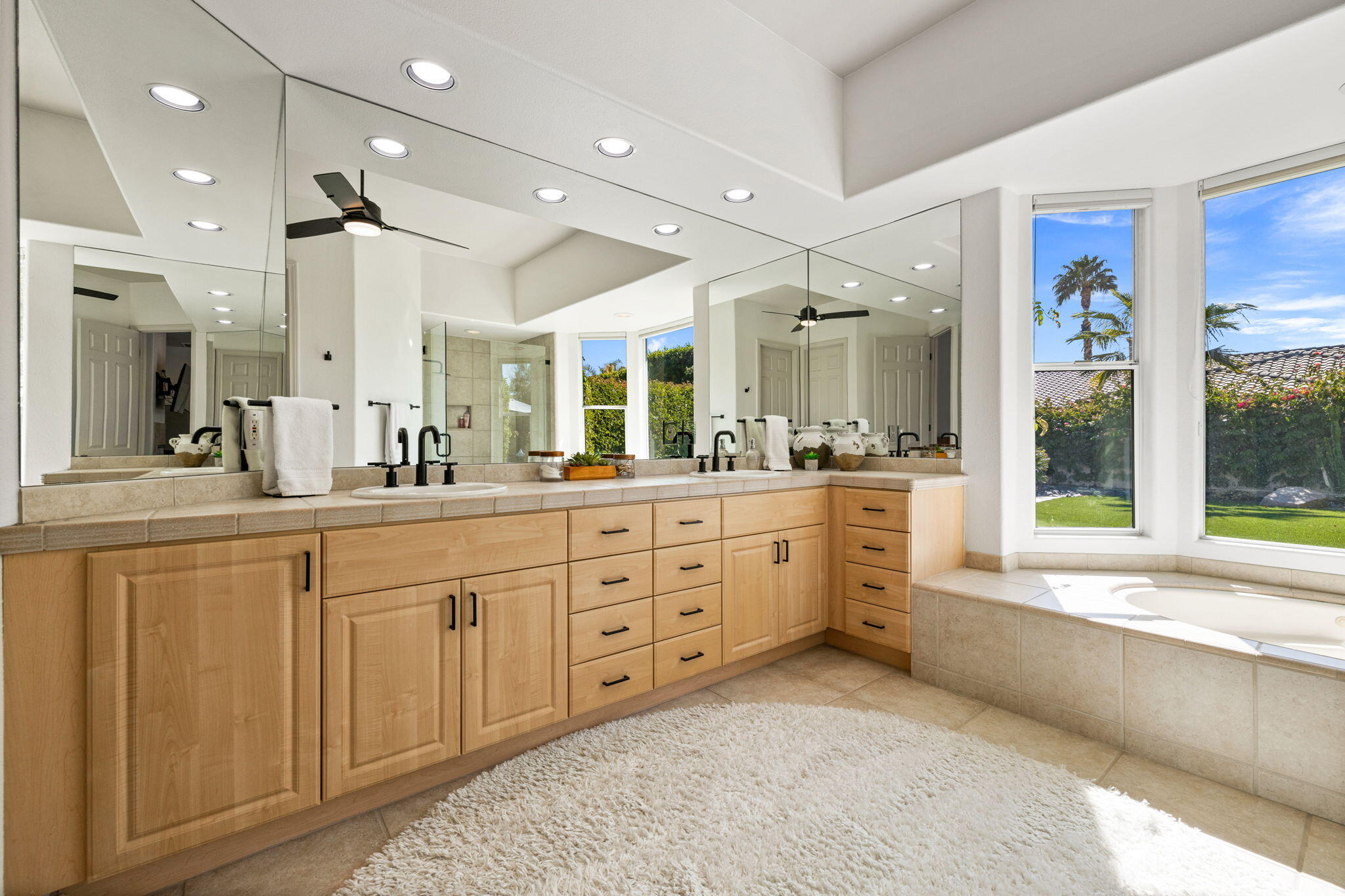 19 Trafagar Square Rancho Mirage, CA 92270 - Photo 27 of 54 a large bathroom with a large mirror vanity and sink