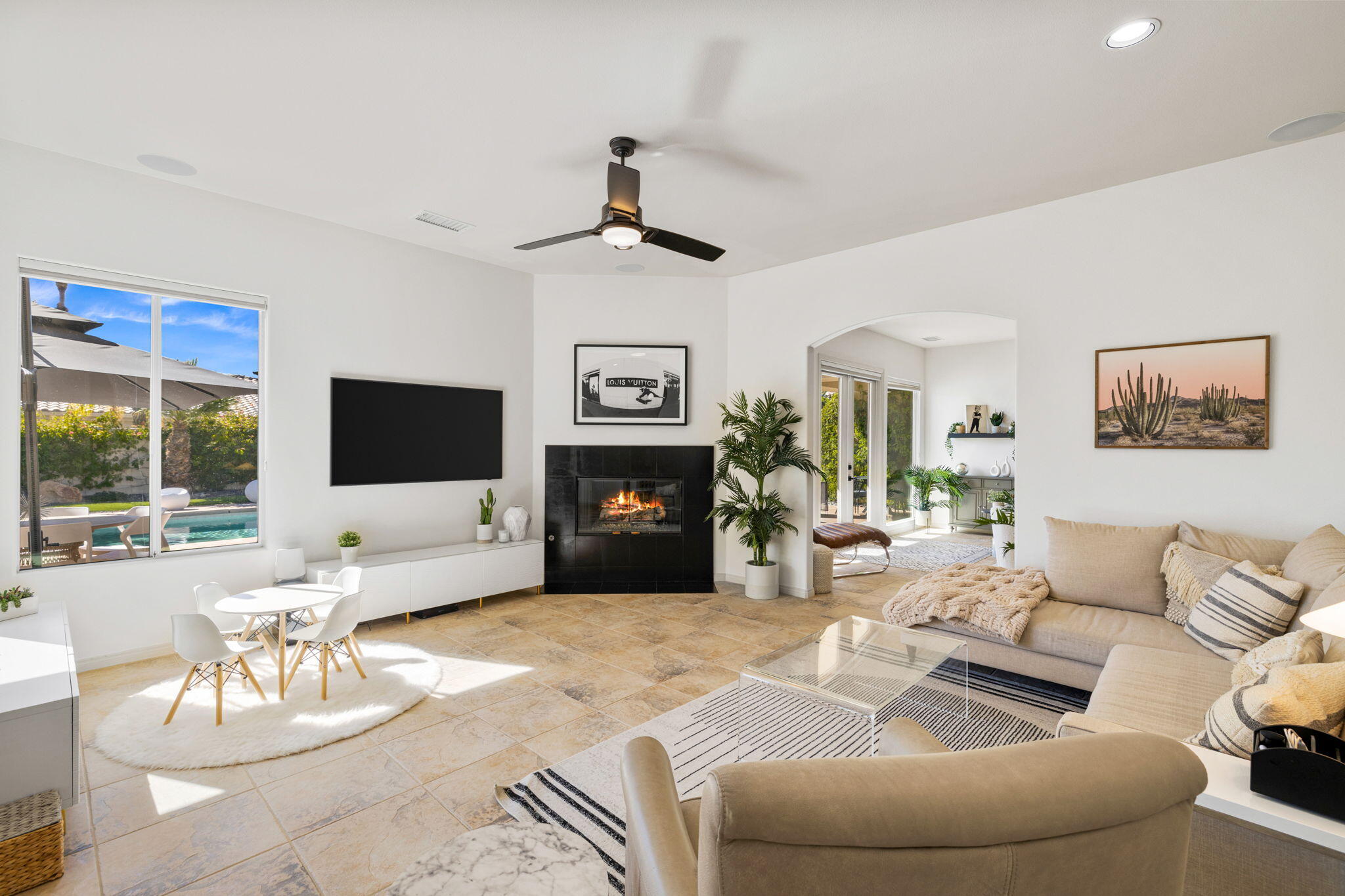 19 Trafagar Square Rancho Mirage, CA 92270 - Photo 37 of 54 a living room with furniture a large window and a flat screen tv
