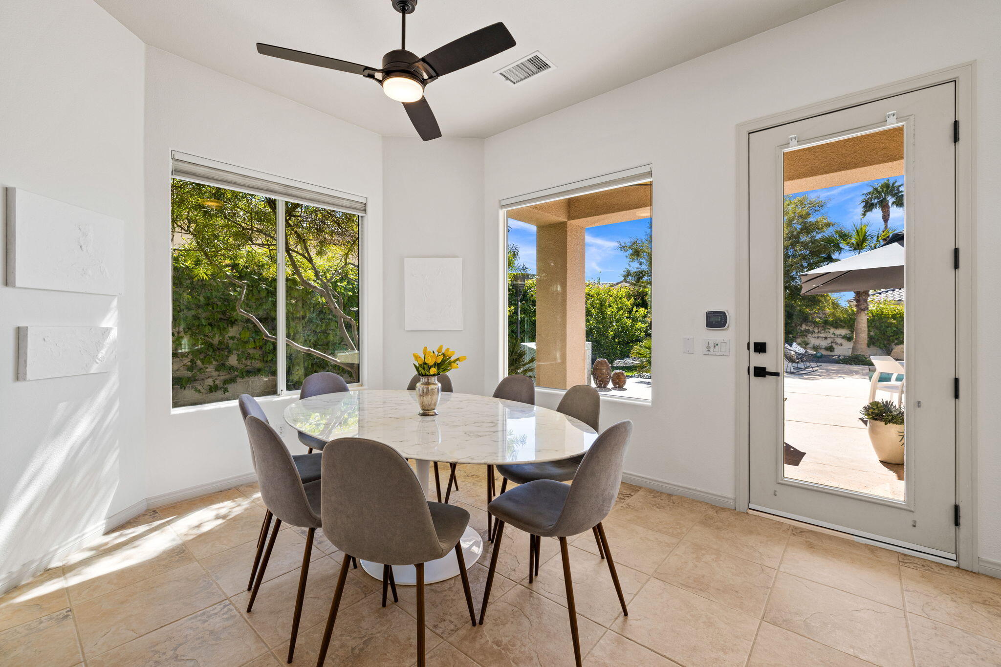 19 Trafagar Square Rancho Mirage, CA 92270 - Photo 39 of 54 a view of a dining room with furniture window and outside view