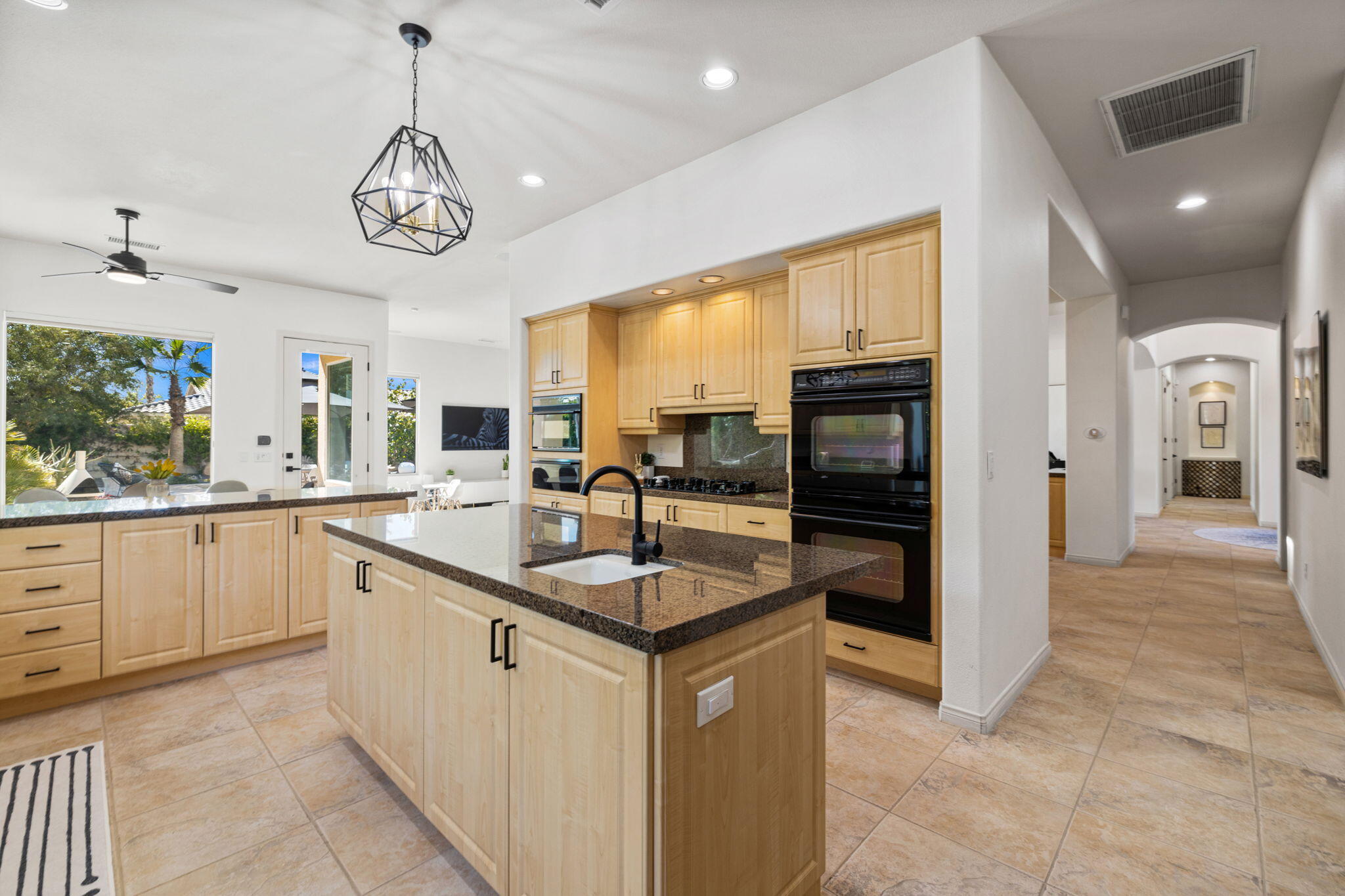 19 Trafagar Square Rancho Mirage, CA 92270 - Photo 40 of 54 a kitchen with stainless steel appliances granite countertop a sink counter space cabinets and stainless steel appliances