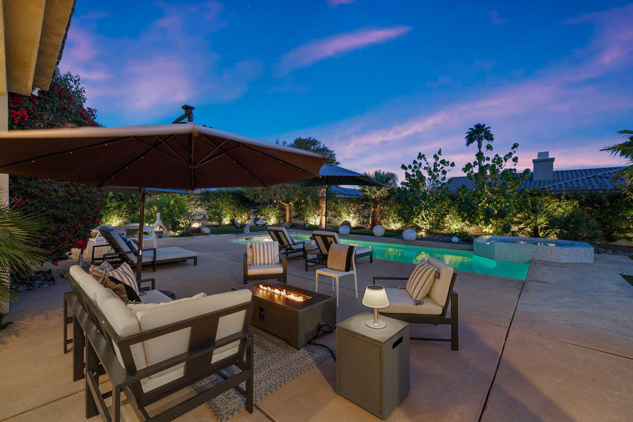 19 Trafagar Square Rancho Mirage, CA 92270 - Photo 49 of 54 a view of a patio with couches under an umbrella