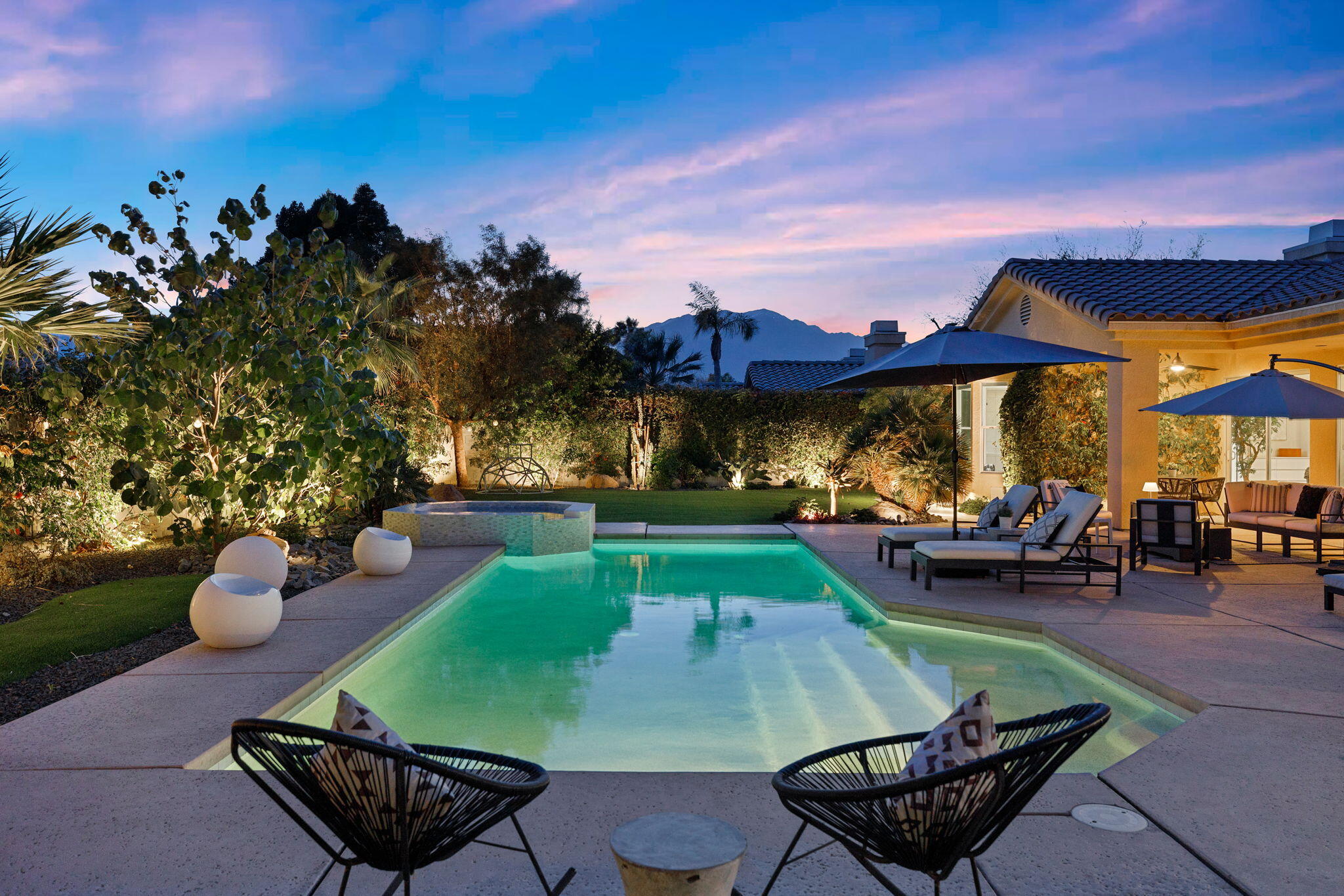 19 Trafagar Square Rancho Mirage, CA 92270 - Photo 5 of 54 a view of a backyard with table and chairs under an umbrella