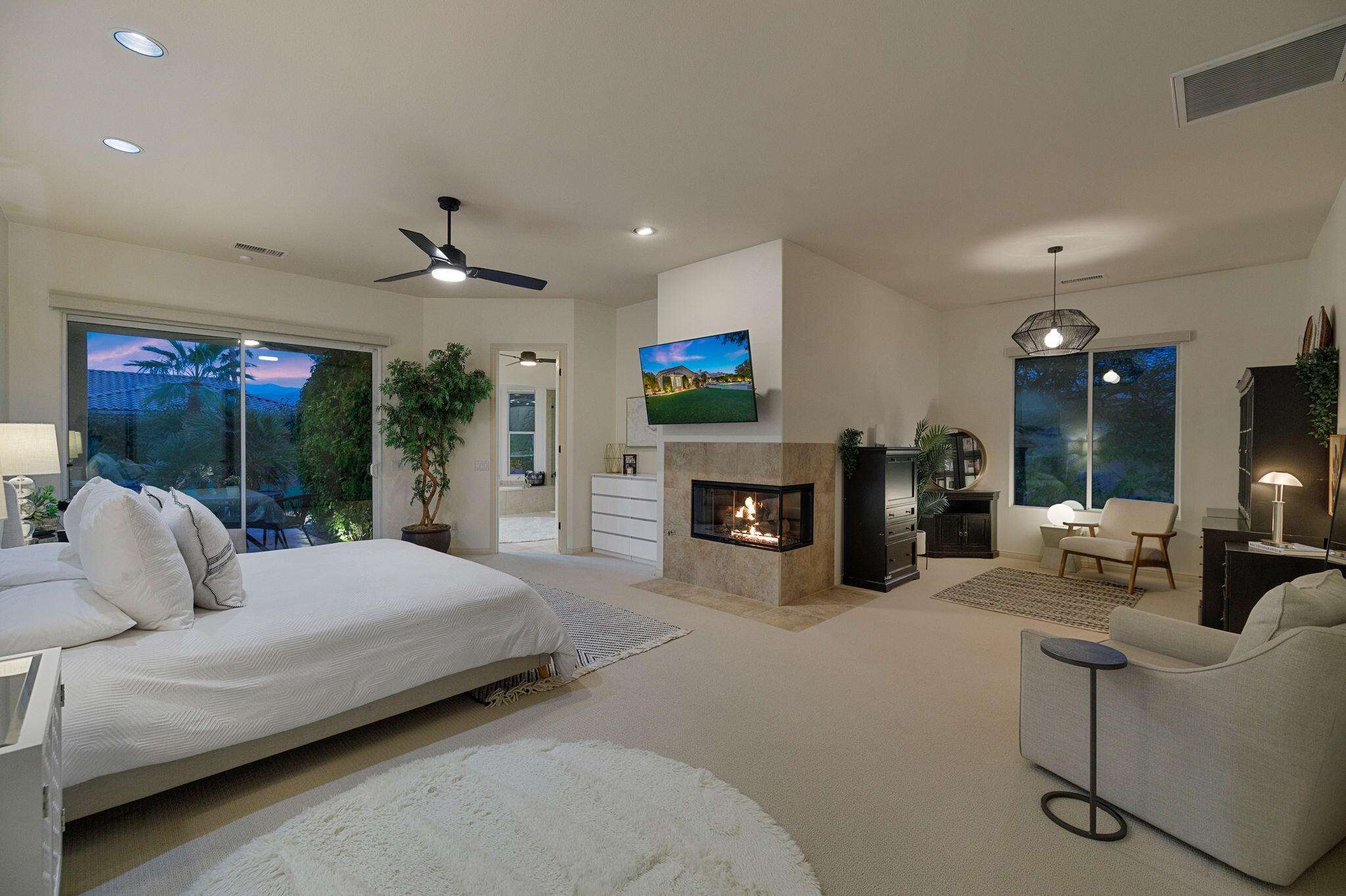 19 Trafagar Square Rancho Mirage, CA 92270 - Photo 52 of 54 a bedroom with a bed a large window and couch