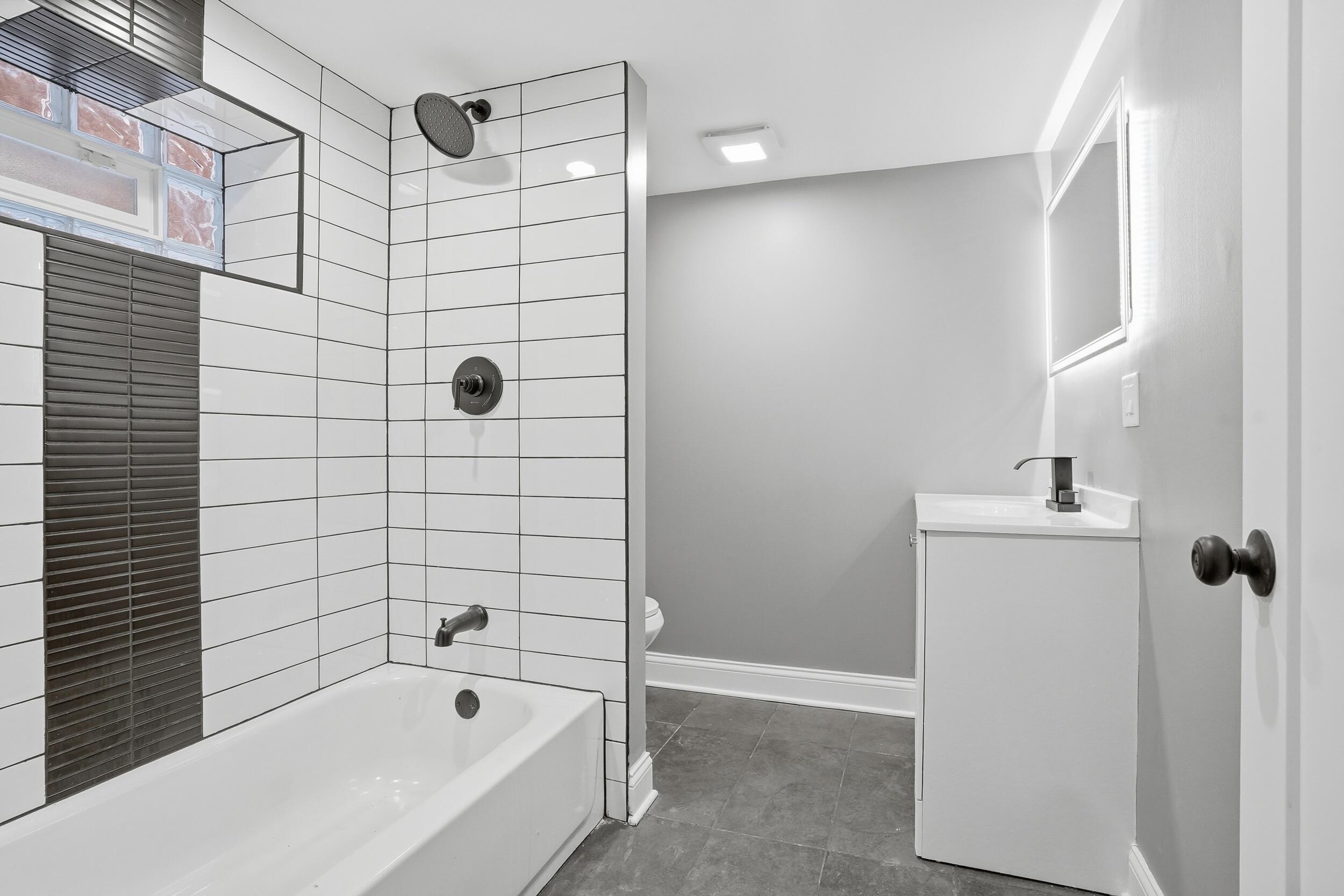 1320 Delaware Street Gary, IN 46407 - Photo 13 of 20 a bathroom with a bathtub and shower