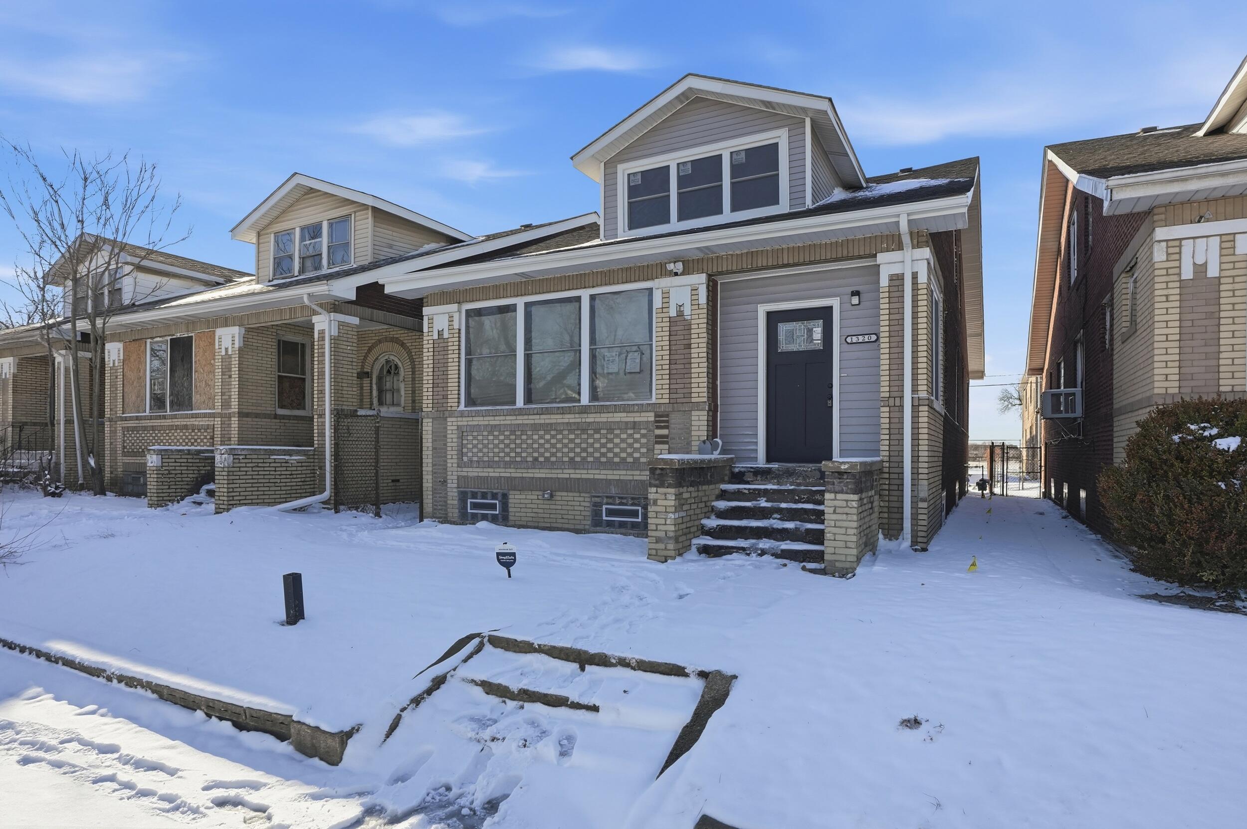 1320 Delaware Street Gary, IN 46407 - Photo 2 of 20 a front view of a house with many windows