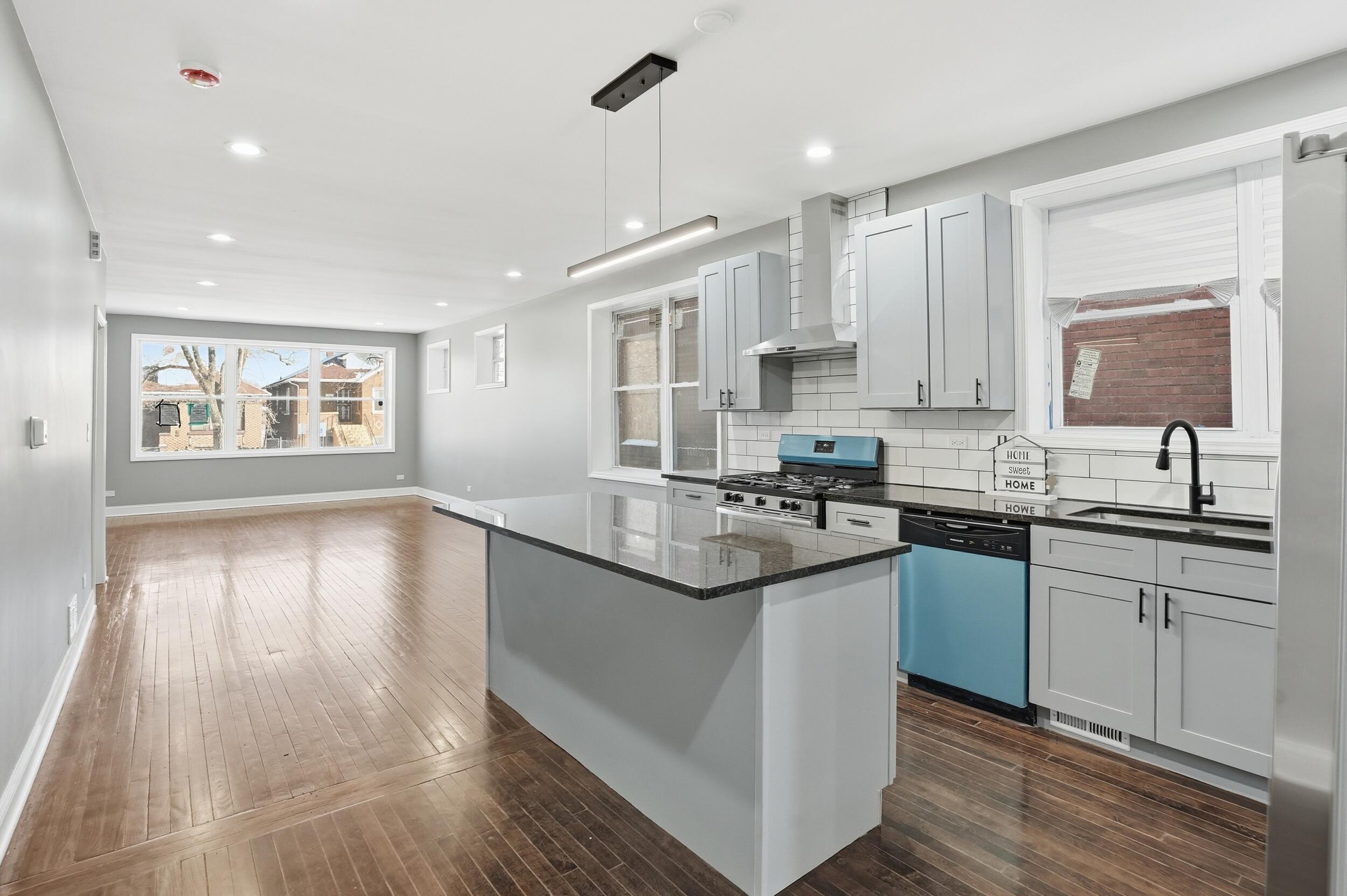 1320 Delaware Street Gary, IN 46407 - Photo 9 of 20 a kitchen with granite countertop a sink cabinets and wooden floor