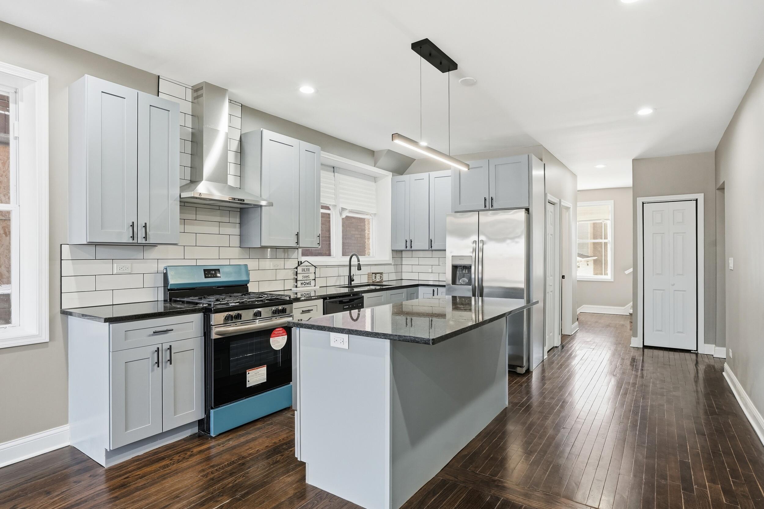 1320 Delaware Street Gary, IN 46407 - Photo 10 of 20 a kitchen with stainless steel appliances granite countertop a sink a stove and a refrigerator
